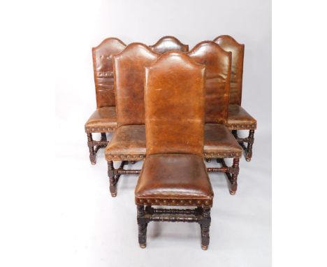 A set of six 17thC style oak dining chairs, with tanned leather button backs and overstuffed seats, raised on turned legs uni