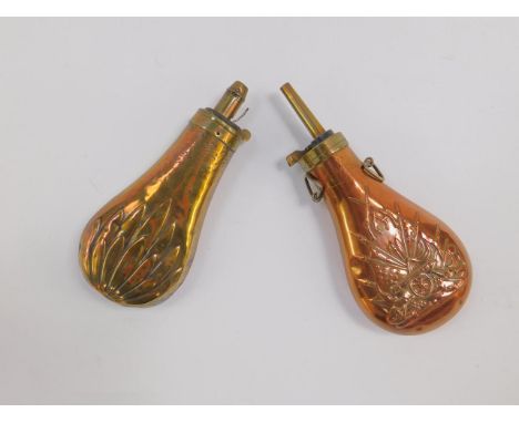 A copper and brass mounted powder flask, embossed with cannons and flags and an embossed brass shot flask, (2).