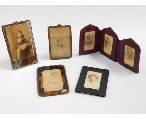 A late 19thC red morocco leather triptych photograph frame, together with four strut frames containing portrait photographs o