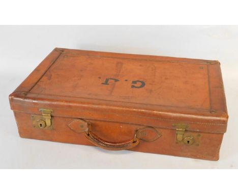 A vintage tan leather suitcase, bearing initials G J, 61.5cm x 35cm x 16cm.