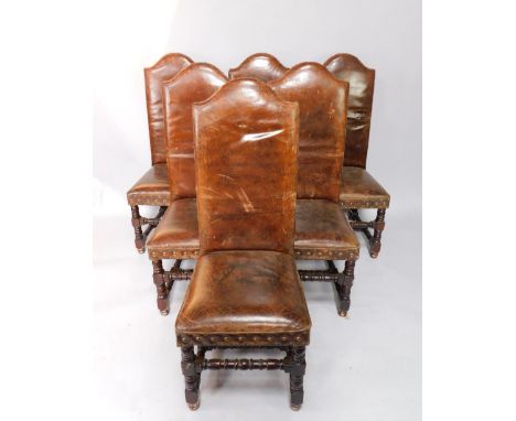 A set of six 17thC style oak dining chairs, with tanned leather button backs and overstuffed seats, raised on turned legs uni