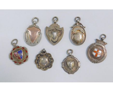 Seven silver medallions, two set with enamel and four sporting presentation engraved, 56.8g.