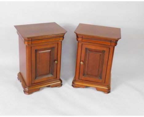 A pair of French late 20thC mahogany pot cupboards, of canted rectangular form, each with a cushion drawer, above a door encl