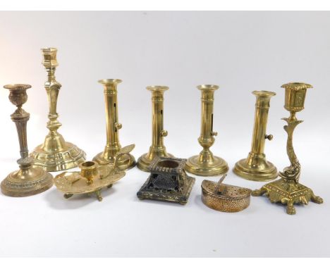 A group of French 19thC and later brass candlesticks, French brass inkwell, chamber stick, and a cooper hand warmer, (10).