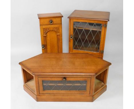 A Fenuinandu oak hi-fi cabinet, with a lead glazed door enclosing a single shelf over a frieze drawer raised on cabriole legs