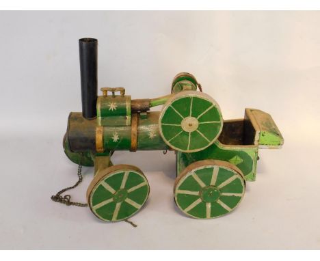 A green painted wooden model of a steam traction engine, 50cm long.