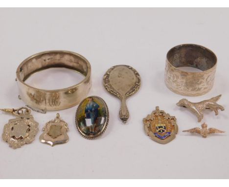 A silver bangle, RAF Wings brooch, dog brooch, two medallions, brooch decorated  with The Blue Boy after Gainsborough, Edward