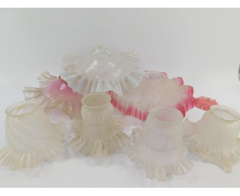 Three French early 20thC frosted or opaline glass lamp shades, 25cm diameter, and four smaller moulded glass lamp shades, (7)