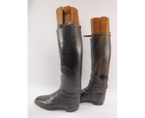 A pair of gentleman's black leather riding boots, with vintage boot trees.