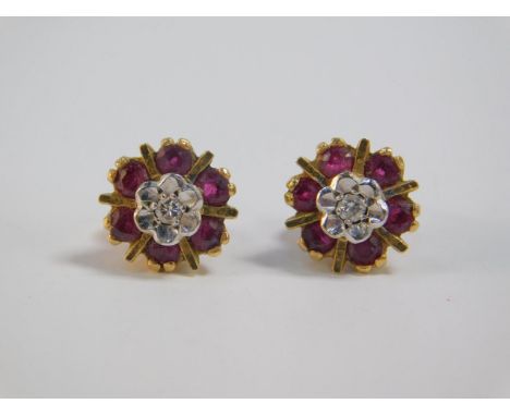 A pair of ruby and diamond flower head earrings, set in yellow metal, stamped 9ct, 2.8g.