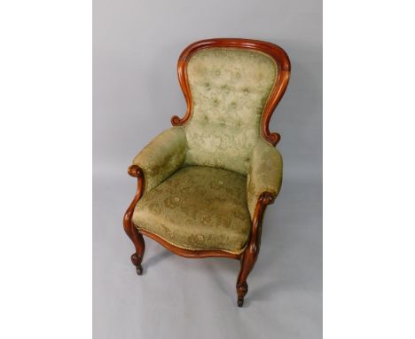 A Victorian mahogany balloon back armchair, with button back floral upholstery, overstuffed seat, raised on cabriole legs on 