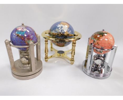 Two revolving hardstone terrestrial globes, the stems set with clock, thermometer, and hygrometer, faces, 10cm diameter, toge