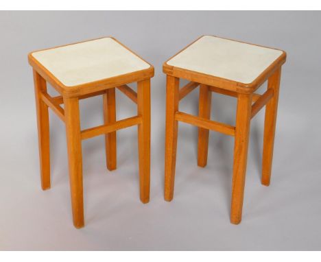 A pair of Czechoslovakian retro light beech stools, of square form with laminate tops, raised on tapering square legs.