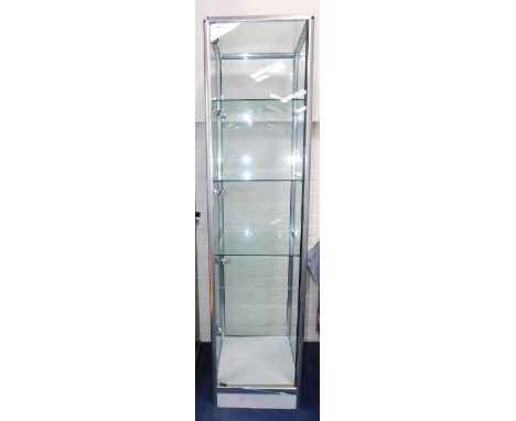 A modern metal framed display cabinet, with glass shelves, and internal lighting, raised on a white base, 50cm x 50cm x 199cm