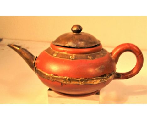 Ceramic and metal saki tea pot. Marked with ceramic factory on base from Thailand. It has a damaged handle. 14 x 11cm. Late 2