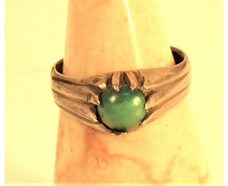 Light turquoise stone set in white metal ring. 