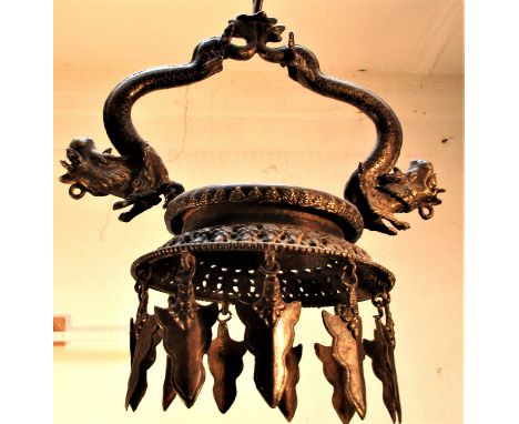 A very special temple lamp from Nepal with dragons supporting the oil dish. Lamps like this are found in many Hindu temples, 