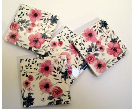 Set of 4 ceramic coasters with red rose designs. 4 rubber cushion pads on bottom. Stored in display box, white designer stres