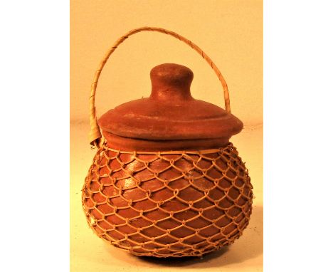 Small ceramic pot covered with fine natural string net. Probably from Lombok. 6 x 9cm. New. 