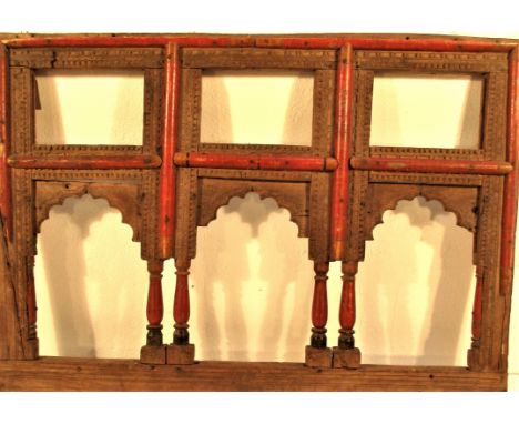 A panel with three arched openings and three squares opening over. This would have been set over a recess in the adobe wall i