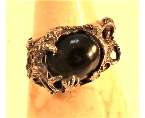 Cast white metal ring of a dragon clutching an onyx stone. 