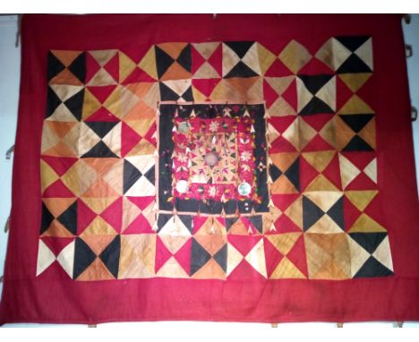 Ceremonial hanging from Bali used in a temple for the 'tooth filing' ceremony.  Patchwork cotton triangles with embroidered c