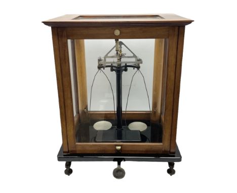 Set of laboratory balance scales by Reynolds & Branson of Leeds in fully glazed mahogany case with rise-and-fall front door, 