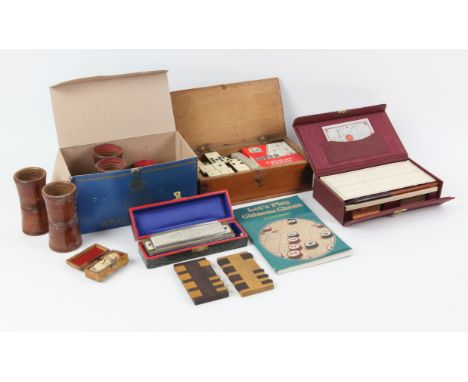 A set of bone and ivory dominos, a miniature set of dominos in a tortoiseshell case, backgammon pieces, whist markers, bridge