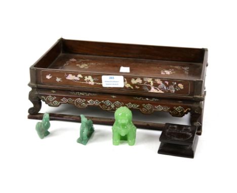 Chinese hardwood stand inlaid with mother of pearl W30cm D19cm H10cm and three green glass figures imitating jade.Sold on beh