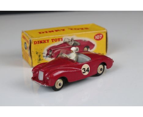 Boxed Dinky 107 Sunbeam Alpine Sports diecast model in cerise, with driver, race number 34, cream hubs, decals vg, some paint