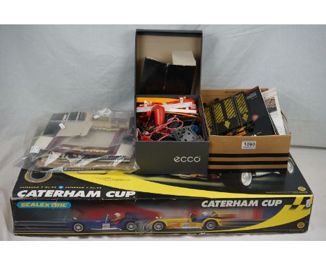 Boxed Scalextric Caterham Cup, appearing complete with two slot cars but unchecked (tatty box), plus accessories, controllers
