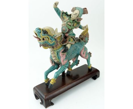 Antique Chinese Pottery Roof Tile On Wood Stand. Depicting a warrior on horseback. Unsigned. Crazing or in good condition. Me