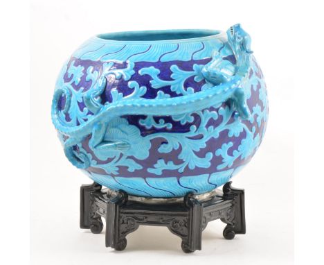 A Worcester Chinese inspired dragon bowl and stand, turquoise and blue glaze, octagonal stand with impressed marks, 29cm over
