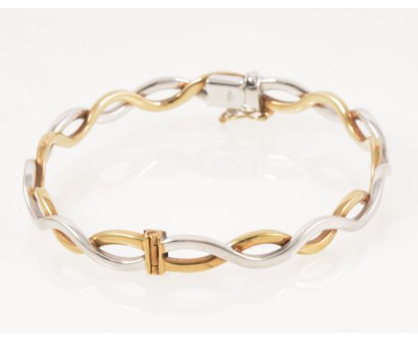 A modern 9 carat yellow and white gold half hinged bangle, 6mm wide two strand, internal dimensions 56mm x 52mm, approximate 