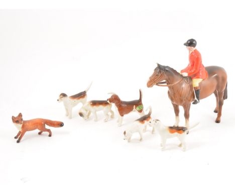 A Beswick pottery model, Huntsman, 21cm, five vartious models of hounds and a model of a fox.