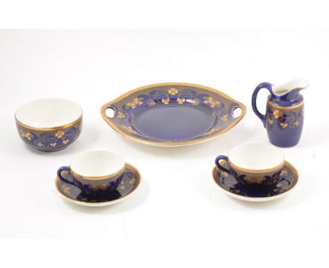 Sarreguemines pottery tea set, gilt printed Art Nouveau design on a cobalt ground, including 11 cups, 12 saucers, 12 plates, 