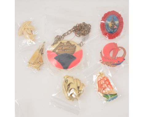 Fourteen novelty vintage bakelite and ivorine brooches with a nautical theme, 1930's-50's, a 67mm circular pendant in red, bl