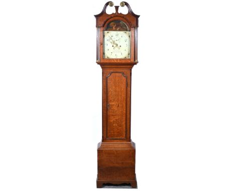 An oak and mahogany longcase clock, swan-neck pediment, with brass roundels, above fluted columns, long door with inlaid shel