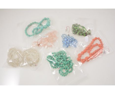 Ten vintage glass and bakelite bead necklaces, a turquoise carved bakelite necklace with graduated beads, another similar cor