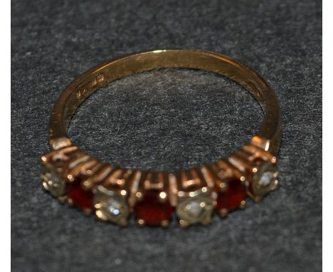 A seven stone ruby and diamond ring