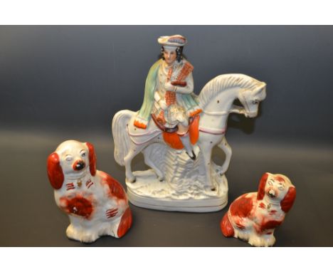 Ceramics - a Stafforshire figure Scotch Piper on Horse back, 29cm high;  a graduated pair of seated spaniels (3) 