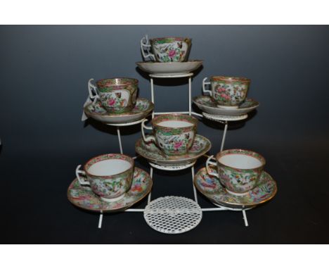 A Cantonese Famille Rose tea service, for six, decorated with figures in a shaped cartouche, the ground with scrolls, butterf