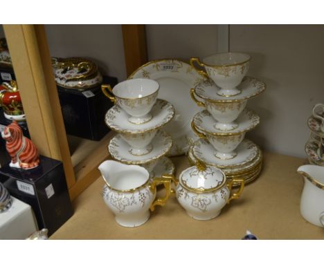 A Royal Crown Derby white glazed vine pattern sucrier and cover, milk jug, bread plate, six teacups, saucers and teaplates, p