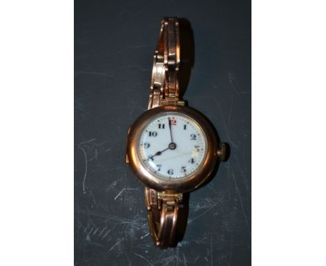 A Vintage Rolex lady's 9ct gold case wrist watch, white enamel dial, Arabic numerals with red 12 o'clock, 15 jewel manual mov