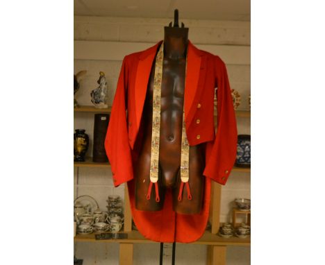 An Edwardian bespoke red hunting tail coat, wool and silk lined, 1907; a pair of braces depicting images of huntsman and houn