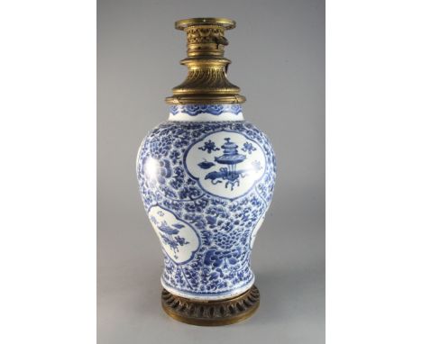 A Chinese blue and white 'antiques and lotus' vase, Qing dynasty, Kangxi period, with gilt metal rim to top, Qing dynasty, an