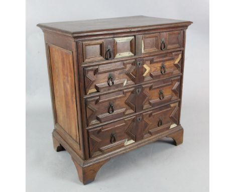 A Charles II oak chest with moulded top above two short and three long drawers, on bracket feet (some reconstruction) 3ft, H.