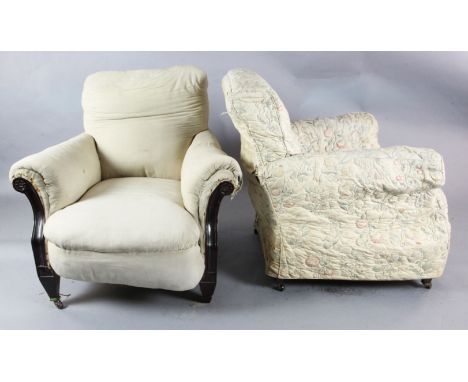 A pair of early 20th century mahogany club armchairs in the manner of Howard & Sons, with paterae carved arms and ceramic cas