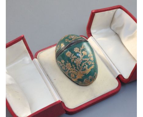 A silver mounted enamel 'egg' bonbonniêre, French, mid 18th century, decorated in raised gilding with cherubs and giant flowe
