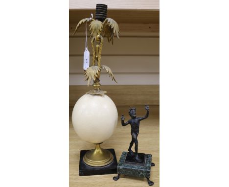 An ormolu egg candlestick and a bronze of a Pan, H.34cm